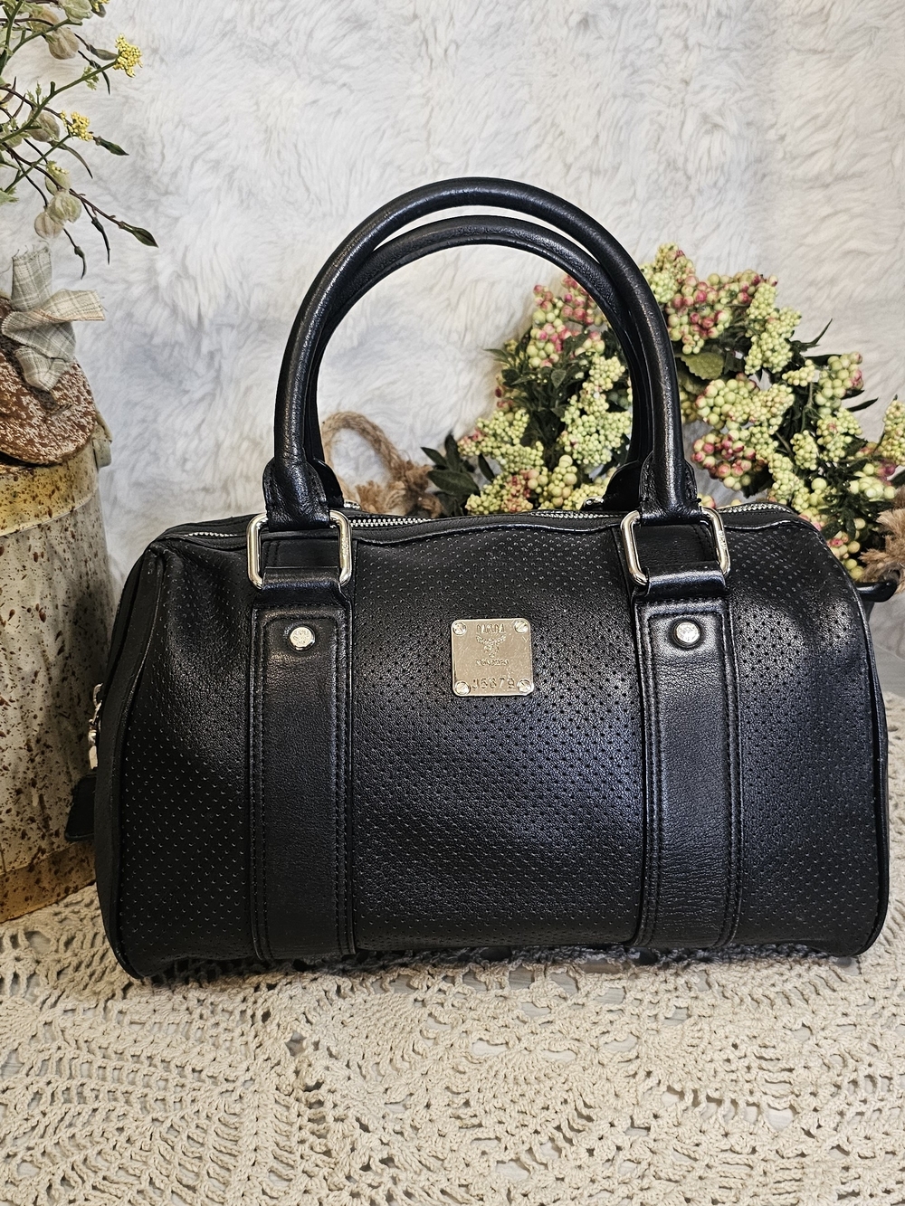 MCM Black Perforated Barrel Satchel with Gold Plaque